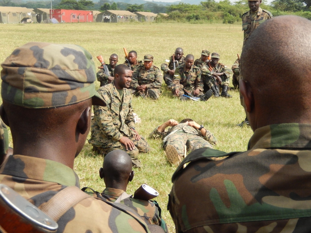 CAMP SINGO, Uganda - Navy Petty Officer 3rd Class Eric Vanette, a corpsman with Special-Purpose Marine Air-Ground Task Force Africa 13.3, gives a class on tactical combat casualty care to Uganda Peoples Defense Force soldiers aboard Camp Singo, Uganda, Aug. 2, 2013. Special-Purpose MAGTF Africa helps Marine Forces Africa and U.S. Africa Command assist partner nations by conducting security force assistance and military-to-military engagements. (U.S. Marine Corps courtesy photo by Lt. Cmdr. Anthony Goiran/Released) 