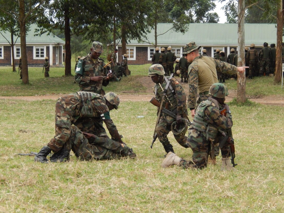 CAMP SINGO, Uganda - A Marine with Special-Purpose Marine Air-Ground Task Force Africa 13.3 observes and instructs Uganda People’s Defense Force soldiers during the practical application aspect of training aboard Camp Singo, Uganda, Aug. 5, 2013. Special-Purpose MAGTF Africa helps Marine Forces Africa and U.S. Africa Command assist partner nations by conducting security force assistance and military-to-military engagements. (U.S. Marine Corps courtesy photo by Lt. Cmdr. Anthony Goiran/Released) 