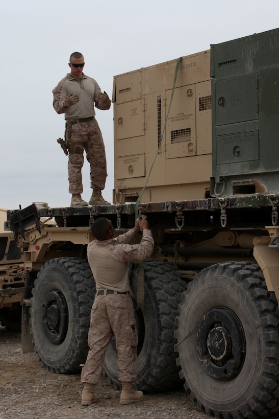 Marines of Combat Logistics Battalion 7 strap down generators next to each other on Forward Operating Base Delaram, Jan. 16, 2014.  Several CLB-7 Marines participated in the combat logistics patrol as they transition into Afghanistan to assumes reponsibilities as the logistics battalion for Regional Command (Southwest).
