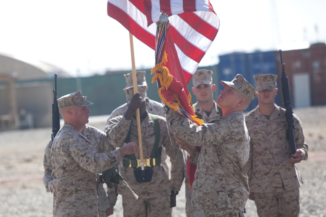 Lieutenant Col. Sidney R. Welch, right, commanding officer, Combat Logistics Battalion 7, uncases the battalion's battle colors during a transfer of authority ceremony aboard Camp Leatherneck, Afghanistan, Jan. 26, 2014. The battalion replaced CLB-6 as the logistics combat element for Regional Command (Southwest) and will provide logistical support to units operating in Helmand province. (U.S. Marine Corps photo by Cpl. Cody Haas/ Released)