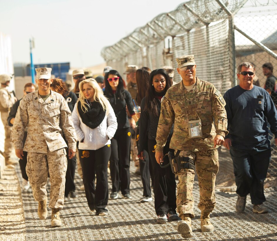 Several Washington Redskins cheerleaders made a trip to support and visit the troops aboard Camp Leatherneck, Afghanistan, Jan. 28, 2014. To show their appreciation for those serving in support of Operation Enduring Freedom, they personally autographed several calendars starring the cheerleaders and posed for photographs with service members. (U.S. Marine Corps photo by Cpl. Cody Haas/ released)