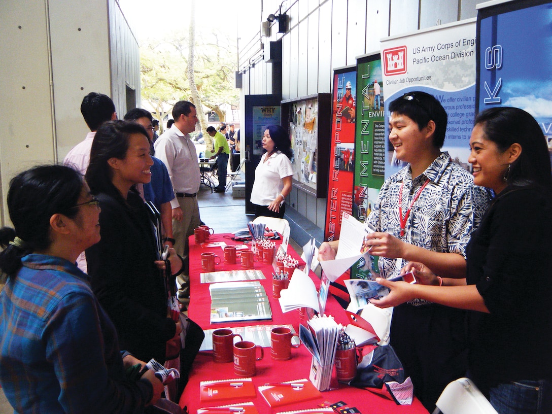 Honolulu District's U.S. Army Interns James Nakamura (second from right) and Jennifer Eugenio (right) talk to students about potential job opportunities and STEm careers within the Corps at a University of Hawaii at Manoa’s College of Engineering Career Fair. 