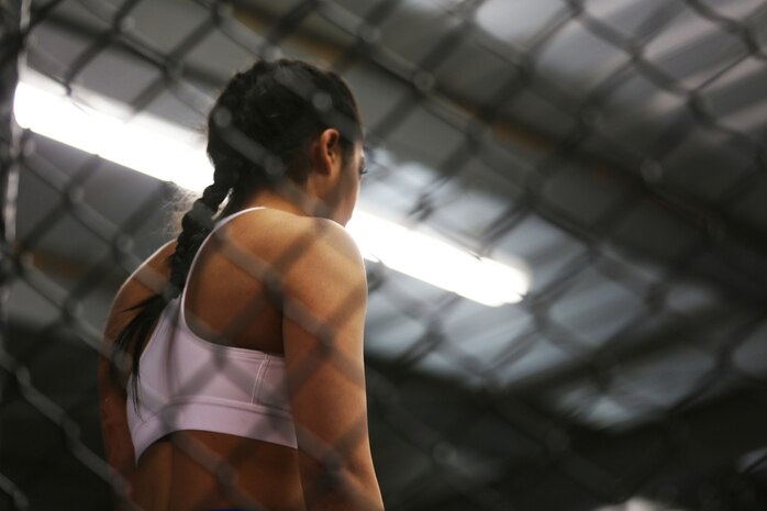 Sergeant Misha Nassiri, an ammunition technician with Headquarters Battalion, 1st Marine Division, faces her opponent in the ring before her first professional mixed martial arts match held at Valley Center, Calif., Jan. 18, 2014. Nassiri, a native of San Diego, won the match by technical knockout in the first 20 seconds of round one. (U.S. Marine Corps photo by Lance Cpl. Jonathan Boynes/released)