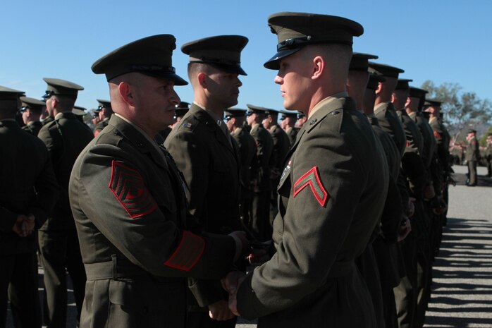 First Sergeant Arturo Blancoromero, Golf Company first sergeant, 2nd Battalion, 4th Marine Regiment, assigned to 5th Marine Regiment, presents the prestigious French Fourragère, a green braided cord, to a Marine during a ceremony at Marine Corps Base Camp Pendleton, Calif., Jan. 22, 2014. Blancoromero, a native of Buena Park, Calif., presented the award to new Marines serving with the regiment. The 5th Marine Regiment is authorized to wear the fourragère by the French government after demonstrating valor in combat in at least three battles during World War I for which the regiment was awarded the Croix de Guerre. The regiment is the most decorated infantry regiment in the Marine Corps and one of the most battle-tested units in the armed services, having fought in fierce battles during World War I, World War II, Korea, Vietnam, Iraq, and Afghanistan. Currently, the regiment provides combat-ready ground forces for deployment worldwide and on U.S. Navy ships in the Pacific and southwest Asia as part of Marine Expeditionary Units.
(U.S. Marine Corps photo by Sgt. Jacob H. Harrer / released)
