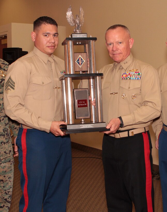 Sergeant Marcos A. Valentin, career planner, 1st Reconnaissance Battalion, receives the Hue City Trophy from Maj. Gen. Larry D. Nicholson, 1st Marine Division commanding general, after being named “Career Planner of the Year” for 1st Marine Division during the 1st Marine Division Annual Career Planning Awards Luncheon at Marine Corps Base Camp Pendleton, Calif., Jan. 27, 2014. Valentin, a 27-year-old native of Mira Mesa, San Diego, and 2004 graduate of Mira Mesa High School, met his retention goal of more than 200 percent during 2013. He is required to interview each of the elite infantrymen that he supports at least two to three times during their careers. In order to accommodate their busy training and deployment schedules, he interviewed many of them during field training and also during early mornings and late nights. Valentin is one of many career planners who serve more than 25,000 combat-ready Marines and Sailors throughout 1st Marine Division.
(U.S. Marine Corps photo by Sgt. Jacob H. Harrer / released)
