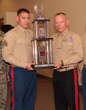 Sergeant Marcos A. Valentin, career planner, 1st Reconnaissance Battalion, receives the Hue City Trophy from Maj. Gen. Larry D. Nicholson, 1st Marine Division commanding general, after being named “Career Planner of the Year” for 1st Marine Division during the 1st Marine Division Annual Career Planning Awards Luncheon at Marine Corps Base Camp Pendleton, Calif., Jan. 27, 2014. Valentin, a 27-year-old native of Mira Mesa, San Diego, and 2004 graduate of Mira Mesa High School, met his retention goal of more than 200 percent during 2013. He is required to interview each of the elite infantrymen that he supports at least two to three times during their careers. In order to accommodate their busy training and deployment schedules, he interviewed many of them during field training and also during early mornings and late nights. Valentin is one of many career planners who serve more than 25,000 combat-ready Marines and Sailors throughout 1st Marine Division.
(U.S. Marine Corps photo by Sgt. Jacob H. Harrer / released)
