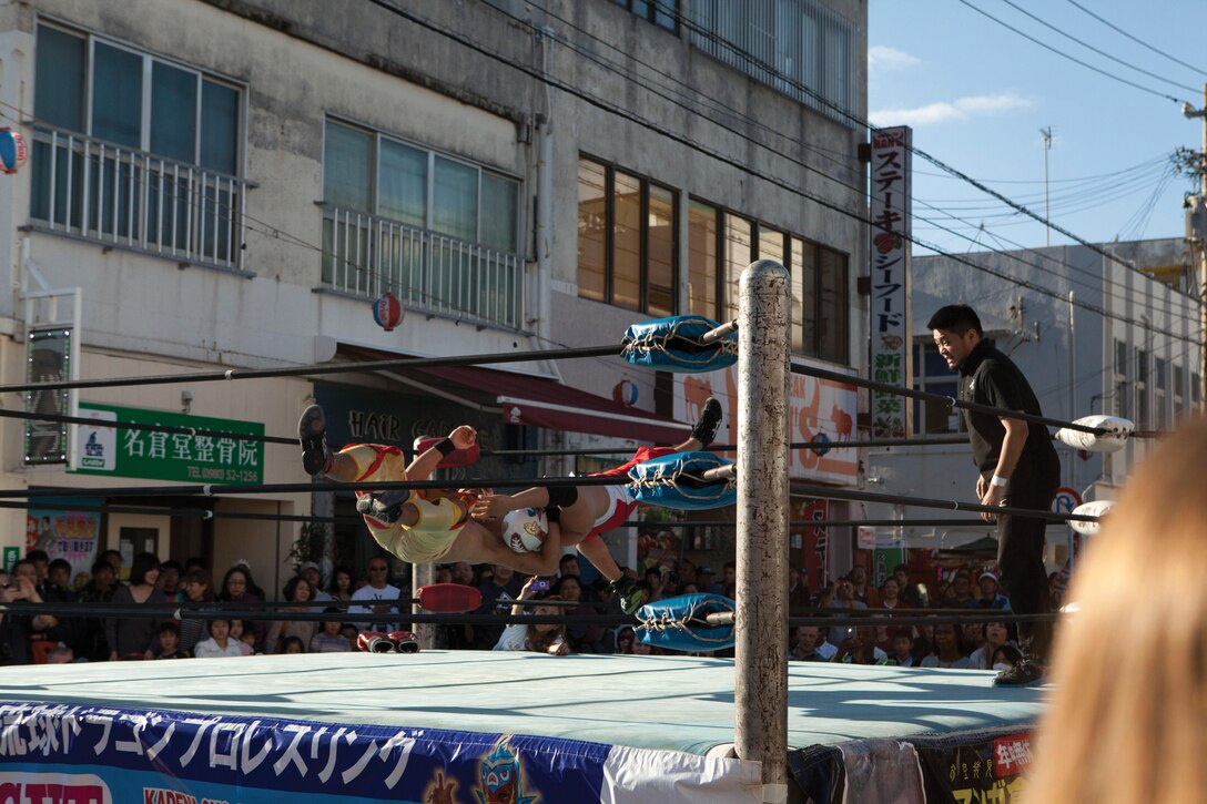 Masked wrestlers of Ryukyu Dragon Pro Wrestling duel it out during Nago’s 52nd annual Cherry Blossom Festival Jan. 25. There were multiple vendors serving food, as well as performances by various artists, including dancers, masked wrestlers and fire breathers. The city of Nago hosts one of the first cherry blossom festivals in Japan, giving the festival its slogan, “Japan’s spring starts here.” 