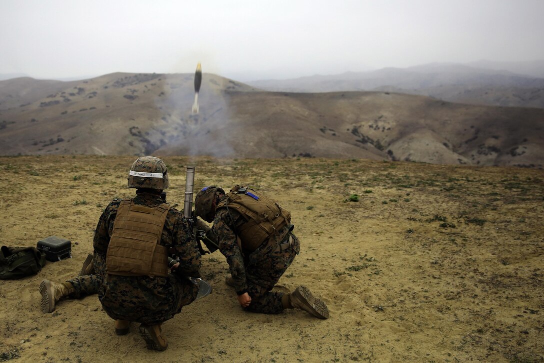 Sgt. Mitchell Savage supervises and instructs Pvt. Tanner Welch and Pvt. Dustin Taylor as they fire the M224 60mm Light Weight Mortar system at Camp Pendleton on Jan. 30. Savage is a mortar combat instructor with Delta Company, Infantry Training Battalion, School of Infantry-West. Both Welch and Taylor are students with Delta Co. and are training to be 0341 mortar men. 

Infantry Training Battalion trains all infantry, entry-level Marines in the infantry skills essential to operating combat environment. Infantry Training Battalion is a 52-day training course that transforms the raw Marine into an infantryman who can fight, survive, and win in a combat situation. 
