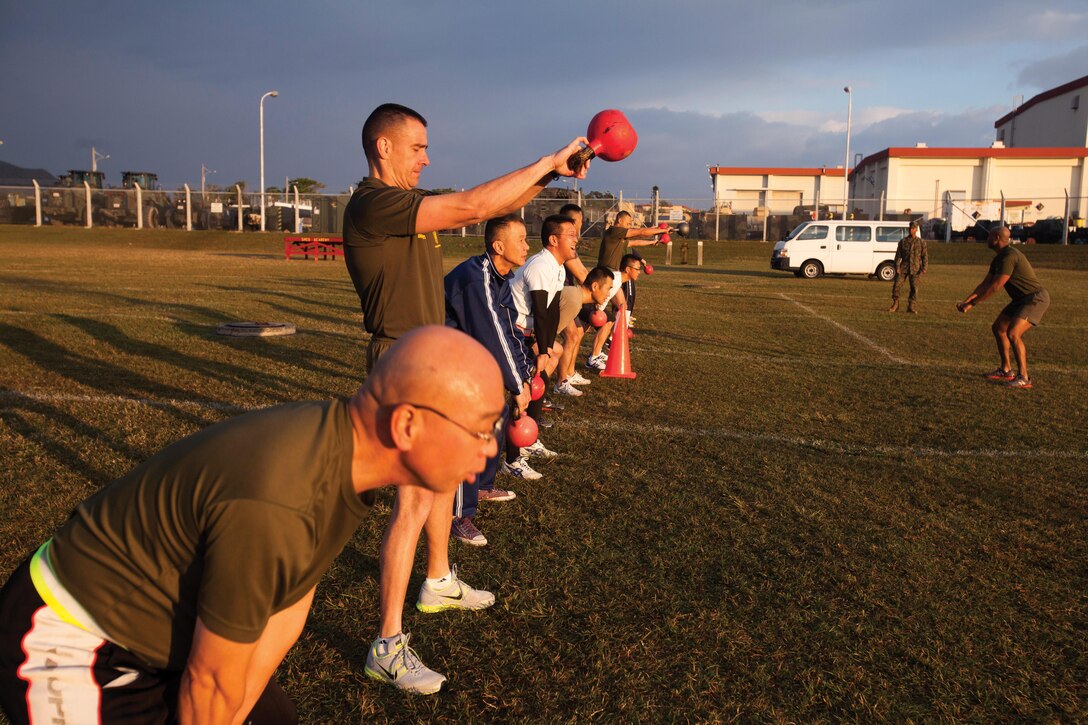 Top enlisted soldiers with the Japan Ground Self-Defense Force and U.S. Marines swing kettle bells during a combat fitness course as part of the Japan Observer Exchange Program Jan. 23 on Camp Hansen. The JOEP is part of a larger effort to strengthen and enhance joint efforts between the U.S. and Japan. The JGSDF soldiers are with various units throughout the JGSDF, and the Marines are with the Staff Noncommissioned Officer Academy, Okinawa. Photo by Cpl. Lena Wakayama