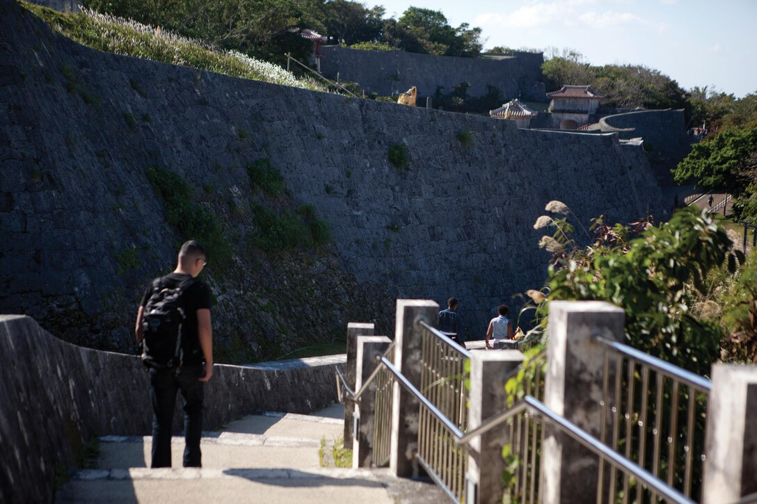Navy Lt. Kevan Q. Lim walks down the stone stairway to the outer courtyard of Shuri Castle Jan. 24 in Naha City. Marines and sailors with Combat Logistic Regiment 37, 3rd Marine Logistics Group, III Marine Expeditionary Force, visited Shuri Castle as part of a historical education event. Lim is the chaplain of CLR-37. Photo by Lance Cpl. Diamond N. Peden