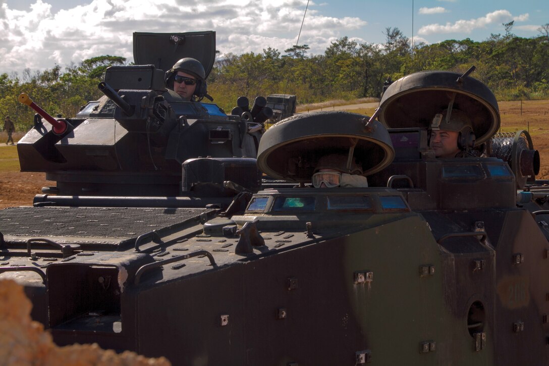 The crew of an assault amphibious vehicle peers out of its hatches awaiting clearance to traverse a demolished tank berm Jan. 21 at LZ Dodo in the Central Training Area. “Over the past decade, we haven’t had to use these core skills,” said Capt. Timothy G. Ernst. “This training event is designed to hone and sharpen our capabilities outlined in the deliberate defense and breaching operations doctrine.” Ernst is the commanding officer of Combat Engineer Co., Combat Assault Bn., 3rd Marine Division, III MEF. The AAV is with Assault Amphibious Vehicle Co., CAB. 