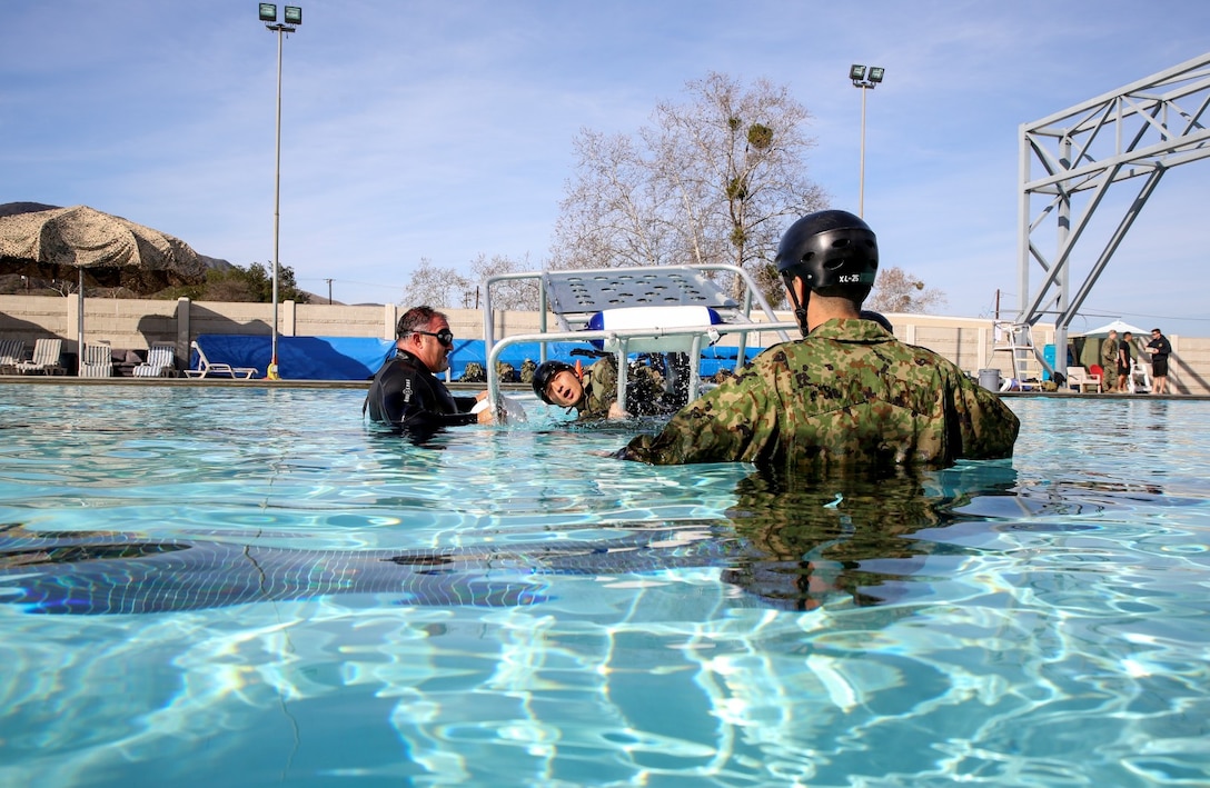 A soldier with the Japan Ground Self-Defense Force takes a breath before being turned upside down in a Shallow Water Egress Trainer while conducting Underwater Egress training during Exercise Iron Fist 2014 aboard Camp Pendleton, Calif., Jan. 23, 2014. Iron Fist is an amphibious exercise that brings together Marines and sailors from the 15th Marine Expeditionary Unit, other I Marine Expeditionary Force units, and soldiers from the JGSDF, to promote military interoperability and hone individual and small-unit skills through challenging, complex and realistic training. (U.S. Marine Corps photo by Cpl. Emmanuel Ramos/Released)