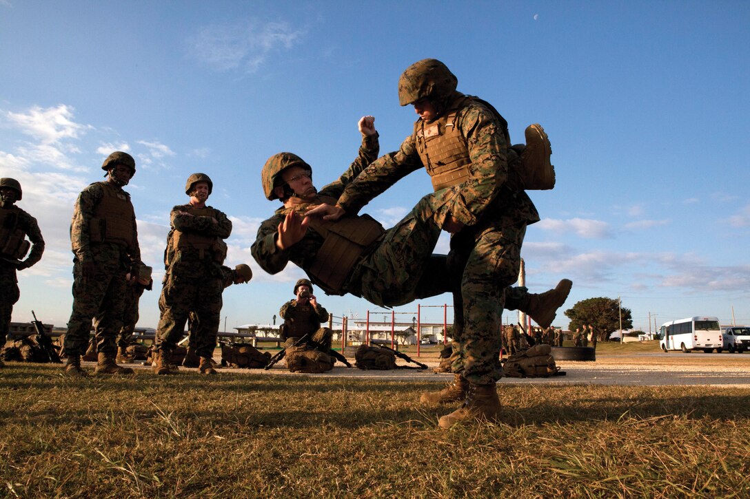 Capt. Gable F. Hackman executes a counter to the round kick on Chief Warrant Officer Nickolas J. Philbrook as part of the Marine Corps Martial Arts Program exercise during the battalion super-squad competition Jan. 23 on Marine Corps Air Station Futenma. The super-squad competition physically challenged the Marines and sailors and brought them together as a unit. The event consisted of various challenges such as a 2.5-mile hike, completion of an obstacle course and Intermediate Combat Rifle Marksmanship live-fire. Hackman is a legal service specialist, and Philbrook is a trial services administrative officer. Both represented H&S Battalion’s Legal Services section. 