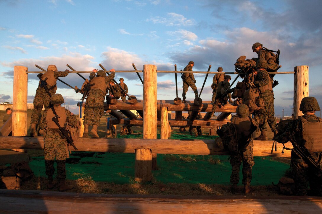 Squads race against time to get across the obstacle course for the title of super-squad Jan. 23 on Marine Corps Air Station Futenma during a battalion super-squad competition. The Marines and sailors are with H&S Bn., MCB Camp Butler.