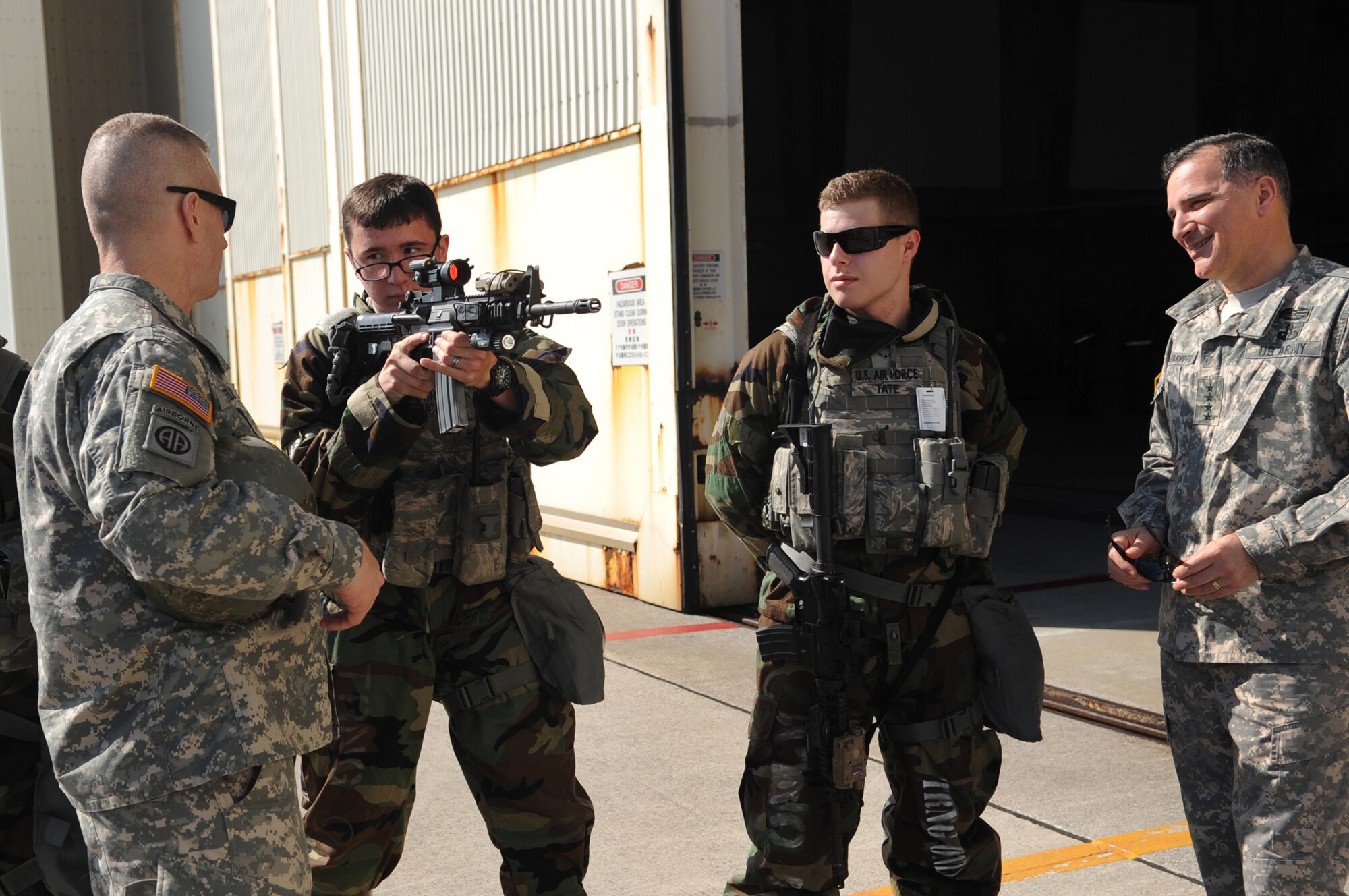 U.S. Air Force Airman 1st Class Thomas Tucker, 18th Security Forces response force member, performs a weapon demonstration for U.S. Army Gen. Curtis Scaparrotti, United States Forces Korea commander, and Command Sgt. Maj. John Troxell, USFK command sergeant major, during a visit to Kadena Air Base, Japan, Jan. 30, 2014. This visit marks Scaparrotti's first visit to Kadena since taking command of USFK in October 2013. Scaparrotti, toured the 18th Wing and spoke with Airmen about the importance of their mission to USFK. (U.S. Air Force photo by Staff Sgt. Amber E. N. Jacobs)
