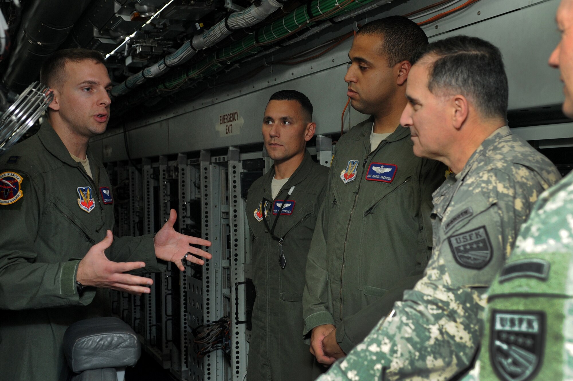 U.S. Air Force Capt. Jordan Matthews, 390th Intelligence Squadron information integration officer, briefs U.S. Army Gen. Curtis Scaparrotti, United States Forces Korea commander, on the mission capabilities of the RC-135 Rivet Joint Aircraft. Scaparrotti came here to meet with the men and women of the 18th Wing and learn more about the mission and the wing?s capabilities in support of USFK. (U.S. Air Force photo by Staff Sgt. Amber E. N. Jacobs)