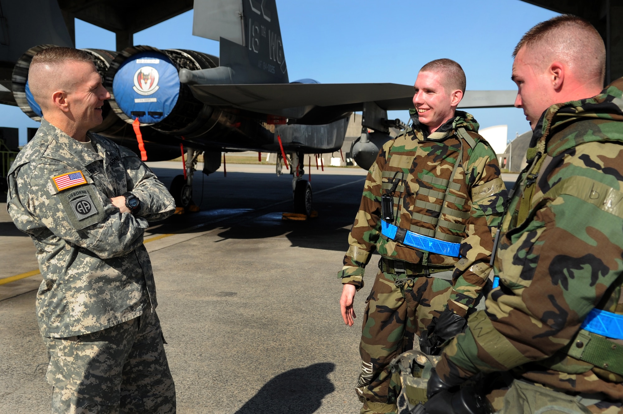 U.S. Army Command Sgt. Maj. John Troxell, United States Forces Korea command sergeant major, talks with two Airmen from the 18th Aircraft Maintenance Squadron during a visit to Kadena Air Base, Japan, Jan. 30, 2014. Troxell toured the 18th Wing and spoke with Airmen about how their mission on Kadena supports the men and women serving in Korea. (U.S. Air Force photo by Staff Sgt. Amber E. N. Jacobs)