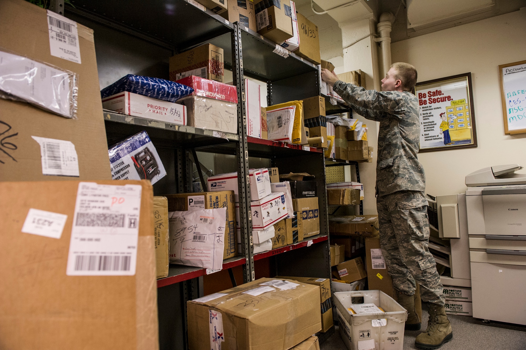 U.S. Air Force Senior Airman Joseph McConnell, 354th Communications Squadron knowledge operations management journeyman, looks for a package Jan. 21, 2014, Eielson Air Force Base, Alaska. Sorting dorm residents’ mail is one of many tasks knowledge operations managers complete daily. (U.S. Air Force photo by Senior Airman Joshua Turner/Released)