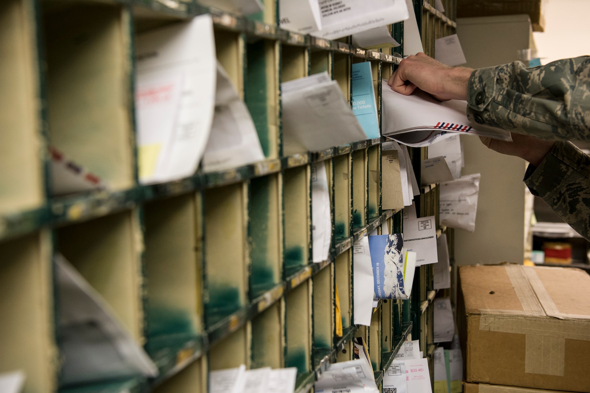 U.S. Air Force Senior Airman Joseph McConnell, 354th Communications Squadron knowledge operations management journeyman, organizes mail Jan. 21, 2014, Eielson Air Force Base, Alaska. On average, the mail room sorts more than 30 pieces of mail and packages per day. (U.S. Air Force photo by Senior Airman Joshua Turner/Released)