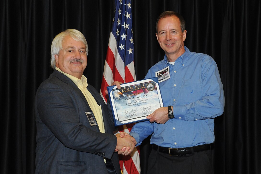 Herman Raiff (left), Ogden Air Logistics Complex executive director, welcomes honorary Dr. Charles Wight, Weber State University President, into their organization. Nearly 45 community members and business leaders were appointed Team Hill Honorary Commanders during an induction ceremony at Hill Air Force Base Jan. 23.  (U.S. Air Force photo by Alex R. Lloyd)
