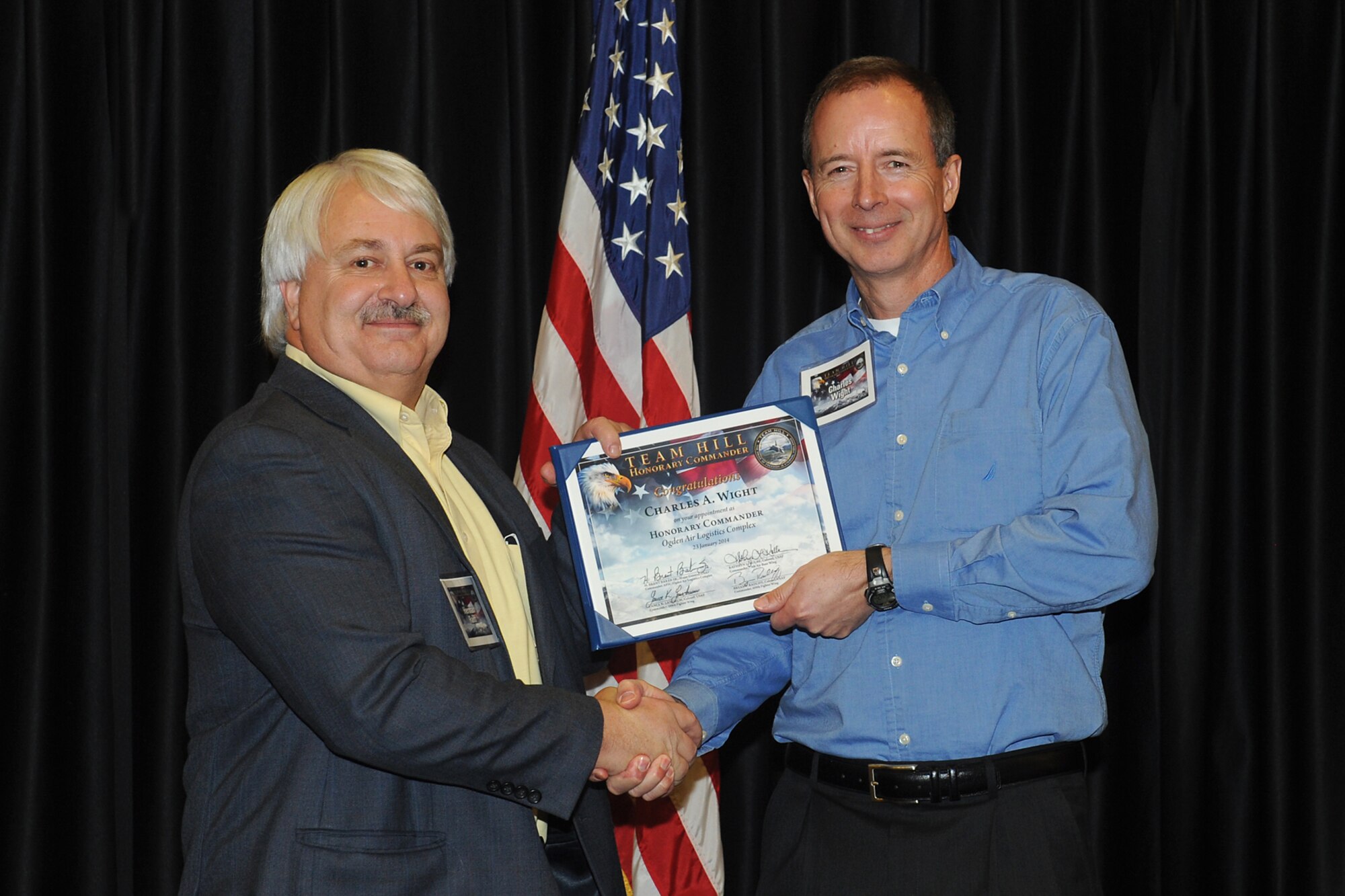 Herman Raiff (left), Ogden Air Logistics Complex executive director, welcomes honorary Dr. Charles Wight, Weber State University President, into their organization. Nearly 45 community members and business leaders were appointed Team Hill Honorary Commanders during an induction ceremony at Hill Air Force Base Jan. 23.  (U.S. Air Force photo by Alex R. Lloyd)
