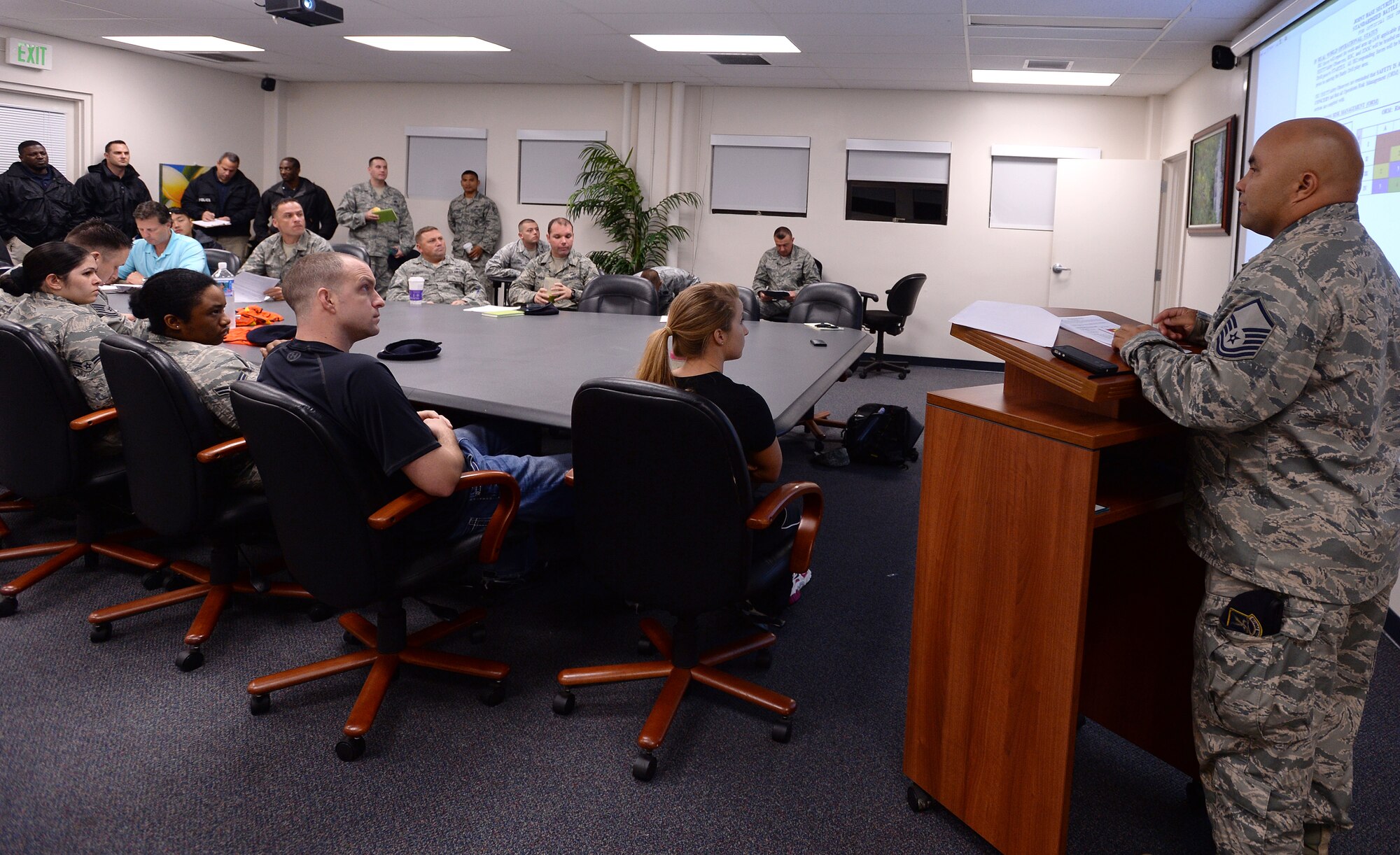 Master Sgt. Robert Wooderson, noncommissioned officer in charge of the 647th Security Forces Squadron Standardization and Evaluations Team, briefs participants of a Joint Exercise Evaluation Training Team active shooter exercise at Joint Base, Pearl Harbor-Hickam, Hawaii, Jan. 29, 2014. The participants included exercise evaluators, Navy police observers, actors playing the roles of shooters and casualties, and first responders from both the Hickam and Pearl Harbor security and police forces. The training enhanced first responder capabilities, and improved security communication and coordination between Hickam and Pearl Harbor. (U.S. Air Force photo/Staff. Sgt. Alexander Martinez)