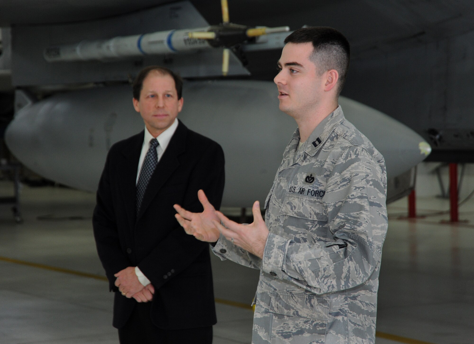 Oregon Air National Guard Capt. Lucas Smith, 142nd Fighter Wing Civil Engineer Squadron, along with Peter West of Energy Trust of Oregon, discusses some of the modifications and enhancements the Portland Air National Guard Base undertook as part of the energy savings initiative with Energy Trust of Oregon during a presentation ceremony at the Portland Air National Guard Base, Ore., Jan. 30, 2014. Energy Trust of Oregon is an independent, nonprofit organization dedicated to helping utility customers benefit from saving energy and generating renewable power.  (Air National Guard photo by Tech. Sgt. John Hughel, 142nd Fighter Wing Public Affairs/Released)