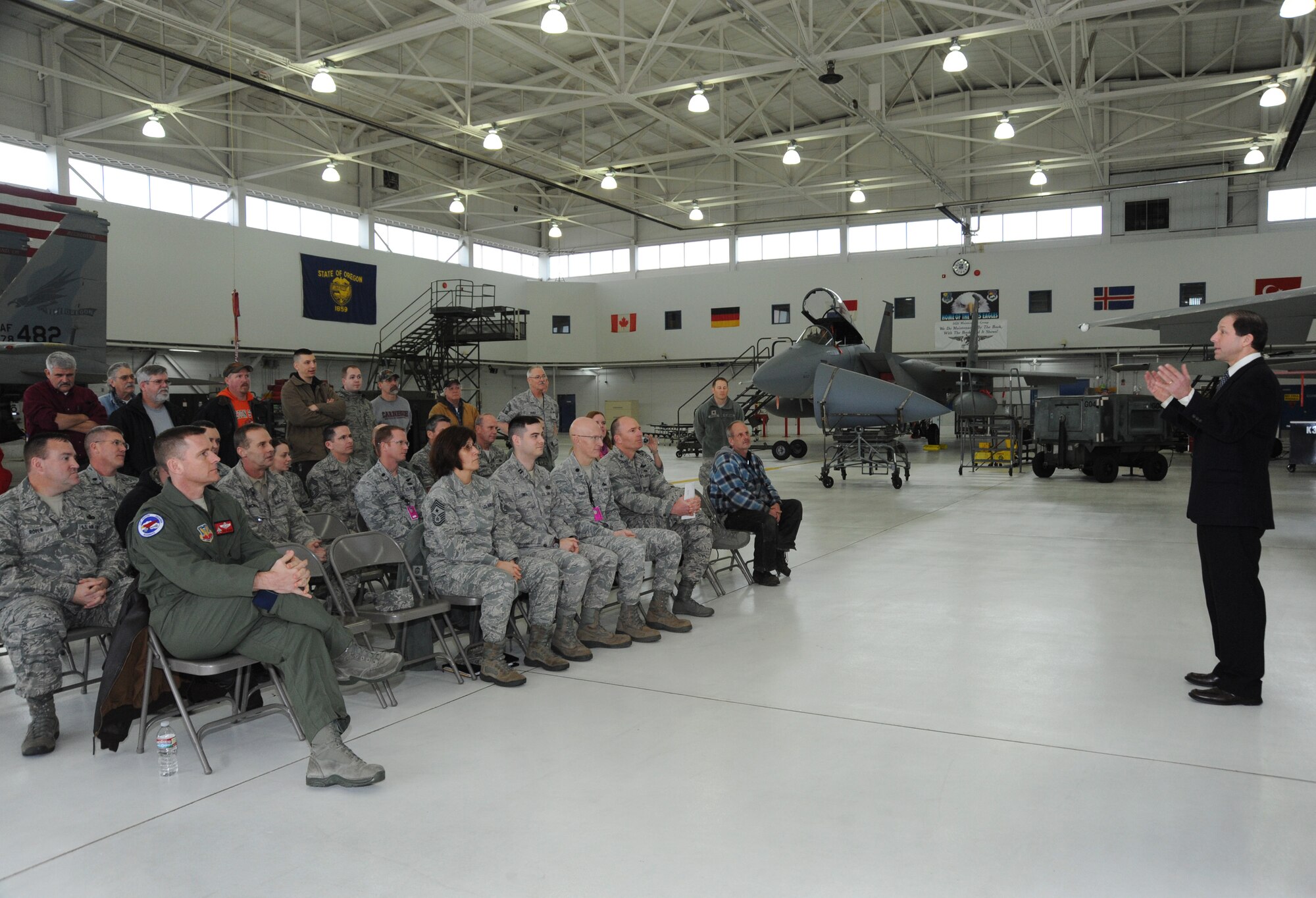 Mr. Peter West (far right) from Energy Trust of Oregon, briefs members of the Oregon Air National Guard during a presentation ceremony at the Portland Air National Guard Base, Ore., Jan. 30, 2014. The Portland Air National Guard Base implemented energy efficiency projects for exterior lighting, aircraft hangar lighting, vehicle maintenance facilities, and flight line lighting, helping to achieve federal energy mandates of reducing energy consumption by three percent each year for 10 years. (Air National Guard photo by Tech. Sgt. John Hughel, 142nd Fighter Wing Public Affairs/Released)