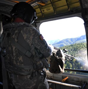U.S. Army Sgt. Shelby Hansen, a flight engineer and unit gunnery trainer assigned to Joint Task Force-Bravo's 1-228th Aviation Regiment, fires an M240 machine gun from a CH-47 Chinook helicopter during aerial gunnery training, Jan. 29, 2014.  Members of the 1-228th conduct aerial gunnery training regularly in order to maintain currency and proficiency on the weapon system.  (U.S. Air Force photo by Capt. Zach Anderson)  