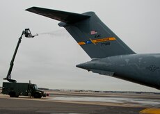 Members of the 437th Maintenance Group de-ice a C-17 Globemaster III on the Joint Base Charleston – Air Base flightline, Jan. 30, 2014. The aircraft was covered in ice from  recent storms. (U.S. Air Force photo/Staff Sgt. William O’Brien)