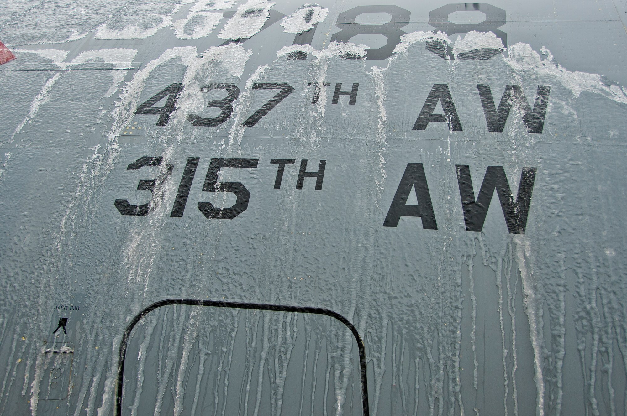 An Ice covered C-17 Globemaster III gets de-iced by the 437th Maintenance Group Jan. 30, 2014, as operations resume at Joint Base Charleston – Air Base following an ice storm. The plane was being de-iced in preparation for a mission later in the day. (U.S. Air Force photo/Staff Sgt. William O’Brien)