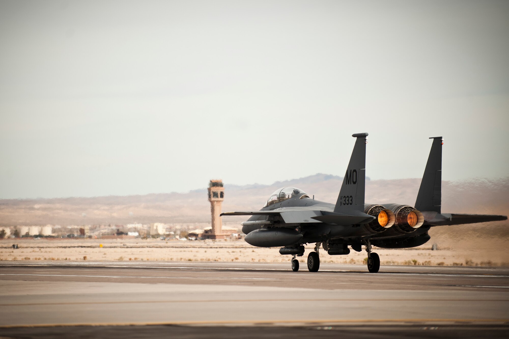 An F-15E Strike Eagle from the 391st Fighter Squadron, Mountain Home Air Force Base, Idaho, fires the afterburner prior to taking off for a training mission Jan. 29, 2014, at Nellis Air Force Base, Nev. During Red Flag exercises, the Air Force’s 2.9 million acre Nevada Test and Training Range plays host to multiple simulated air wars that provide the most realistic training possible for U.S. and coalition pilots. (U.S. Air Force photo by Airman 1st Class Joshua Kleinholz)
