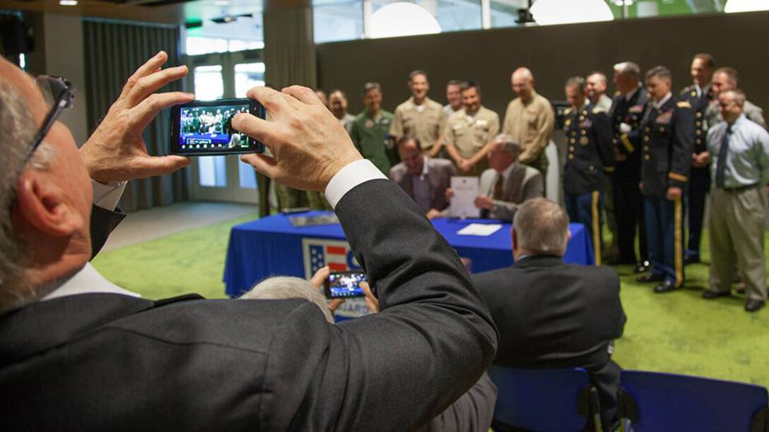 TRAVIS AIR FORCE BASE, Calif. -- Laszlo Bock, Google Inc, Senior Vice President for People Operations (left), speaks with Col. Matt Burger, commander of the 349th Air Mobility Wing; and Paul E. Mock, ESGR National Chair (right), after Bock signed a Statement of Support for the Guard and Reserve at Google headquarters in Mountain View, Calif., Jan. 21, 2014. (U.S. Air Force / Lt. Col. Robert Couse-Baker) 