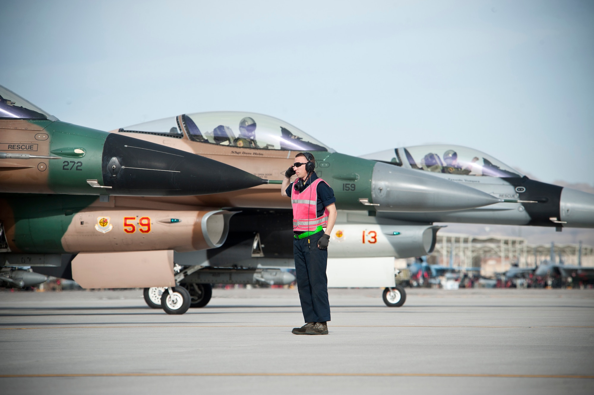 Staff Sgt. Wesley Ott, 57th Aircraft Maintenance Squadron Viper Aircraft Maintenance Unit dedicated crew chief, renders a salute to an F-16 Fighting Falcon pilot prior to a Red Flag 14-1 training mission Jan. 29, 2014, at Nellis Air Force Base, Nev. The 64th AGRS's mission is to prepare the combat air forces, joint and allied aircrews for potential conflicts or war with challenging and realistic threat replication, training, academics and feedback. (U.S. Air Force photo by Lorenz Crespo)