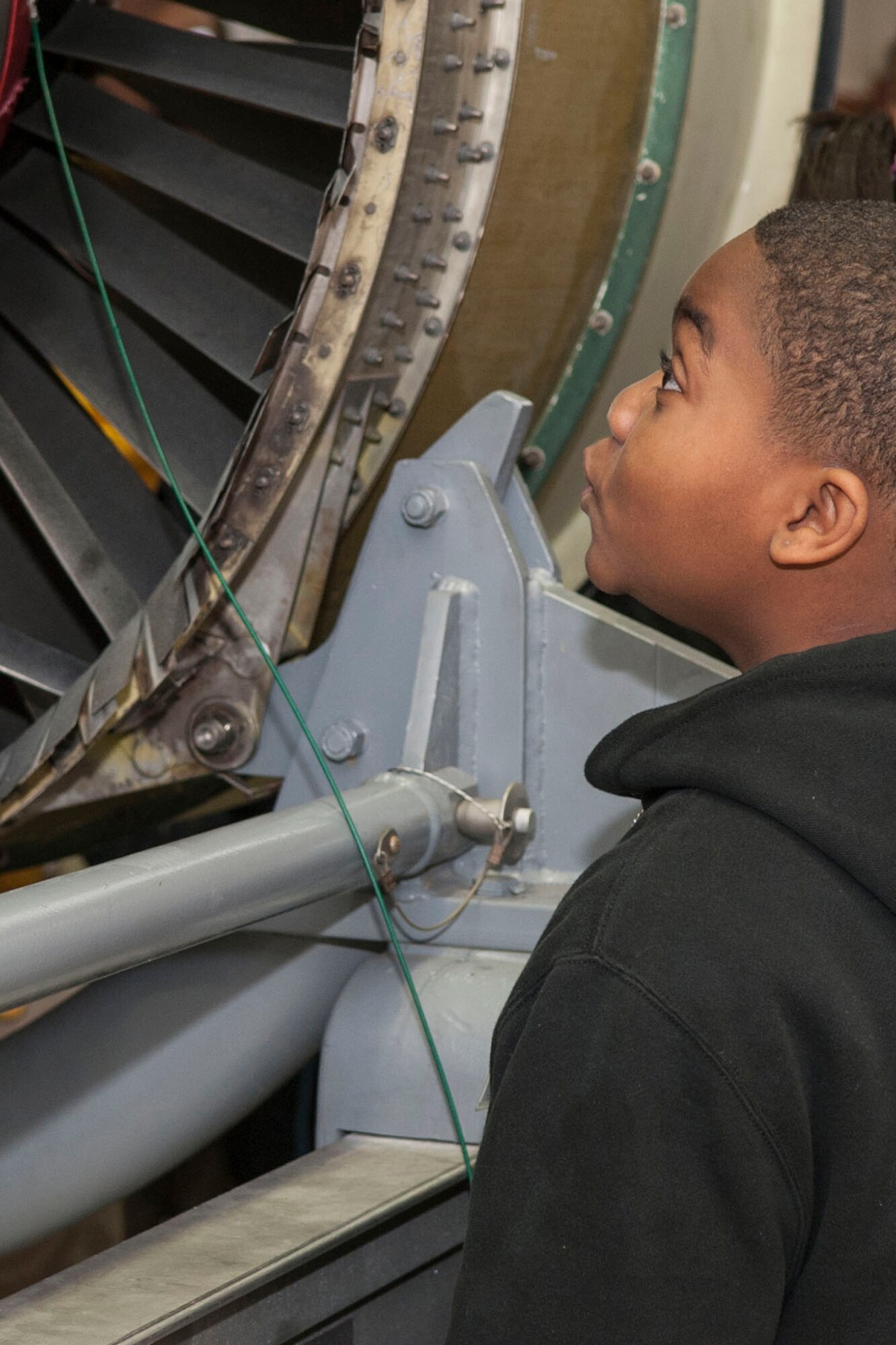 A 5th Grade student from Southern Hills Elementary, Shreveport, La., examines a TF-34 jet engine, which is a military turbofan engine, used on the A-10 Thunderbolt II, during a tour of the engine shop at Barksdale Air Force Base, La., Jan. 29, 2014. The student was attending STARBASE Louisiana, which is one of over 70 national STARBASE sites and is sponsored by the 307th Bomb Wing. (U.S. Air Force photo by Master Sgt. Jeff Walston/Released) 