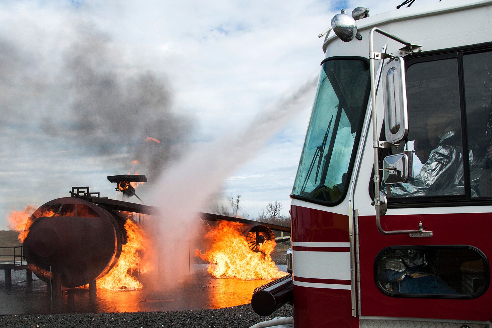 U.S. Air Force Maj. Gen. Robert Rego, Air Force Global Strike Command vice commander, operates the water cannon on a fire truck, Jan. 26, 2014, Barksdale Air Force Base, La. Rego joined the 307th Civil Engineer Squadron during their annual firefighting certification training to practice extinguishing a fire on a large frame aircraft. (U.S. Air Force photo by Tech. Sgt. Theodore Daigle/Released)