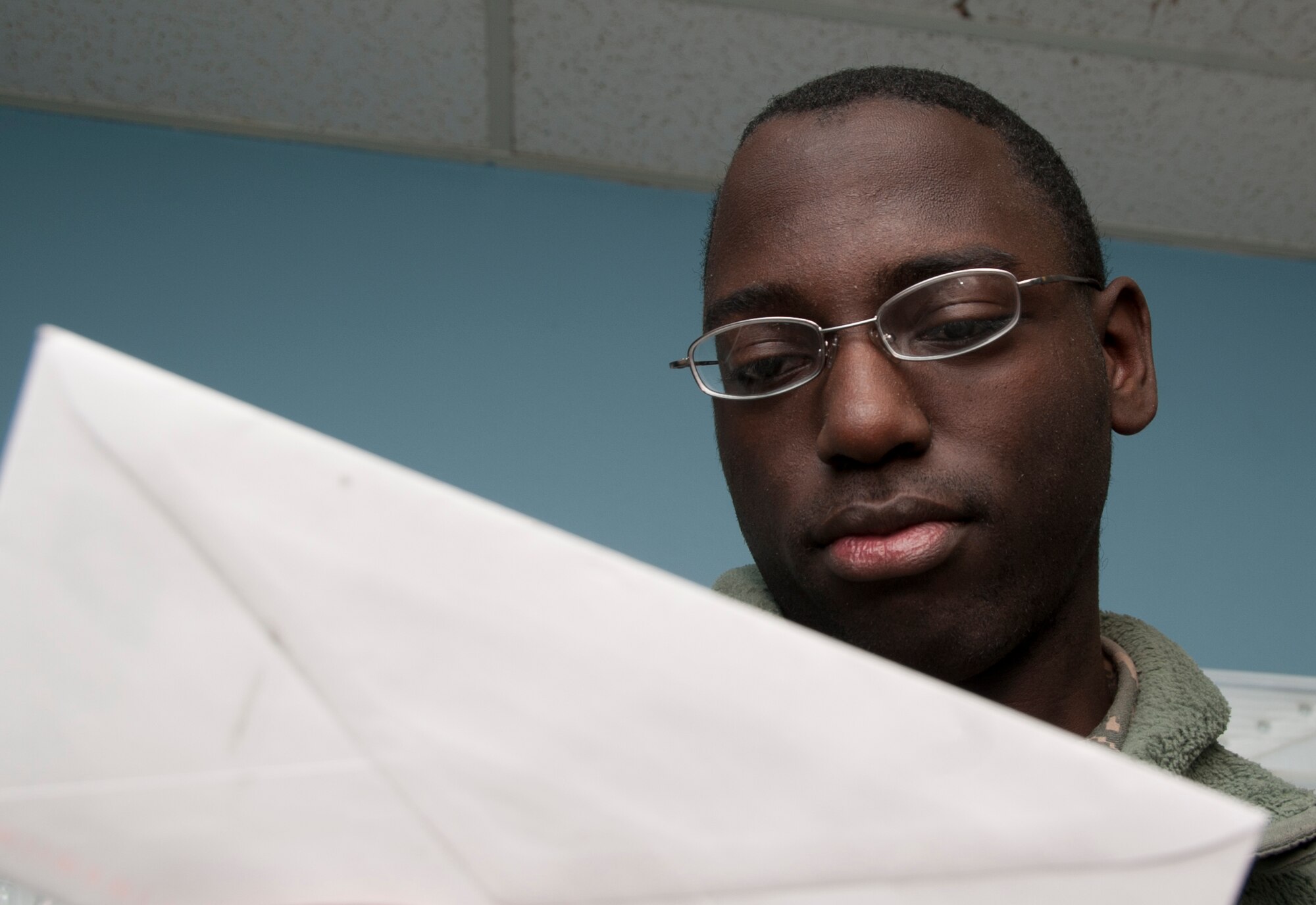 ALTUS AIR FORCE BASE, Okla. – U.S. Air Force Airman Fred Taylor, 97th Communications Squadron knowledge operations management, looks over mail that is to be distributed on base at the official mail center Jan. 29, 2014. The official mail center separates all mail sent to and from squadrons ensuring it is delivered to the proper location. (U.S. Air Force photo by Senior Airman Franklin R. Ramos/Released)