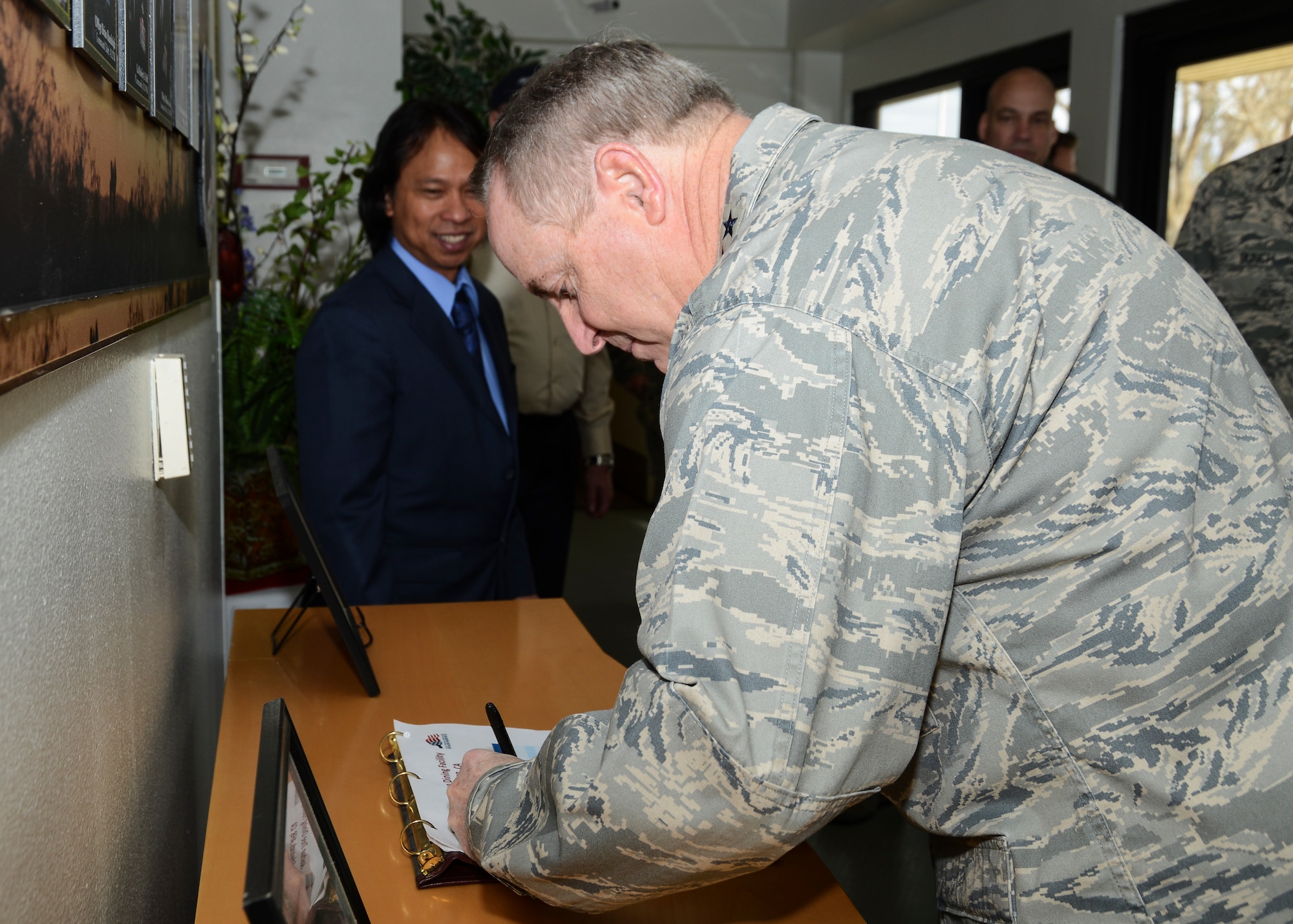 Gen. Mark A. Welsh III, Air Force chief of staff, signs the guestbook at the Joshua Tree Dining Facility Jan. 29. Welsh, along with his wife, Betty, is visiting Edwards AFB to meet with Team Edwards Airmen and their families, as well as receive updates on test programs to include the fifth-generation F-35 Joint Strike Fighter program. (U.S. Air Force photo by Rebecca Amber)