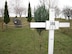 In the foreground the white wooden cross erected in 1990 by Vogelsberg, Germany Mayor Gerhard Harsch at the memorial site created to honor three American Airmen killed in a 1964 T-39 mishap over Erfurt, East Germany. The stone memorial seen in the background was placed at the site in 1998 by the citizens of Vogelsberg. A 50th anniversary memorial cerebration ceremony will be held at the site on Feb 2.  (Photo by Gerlinde Schmidt).