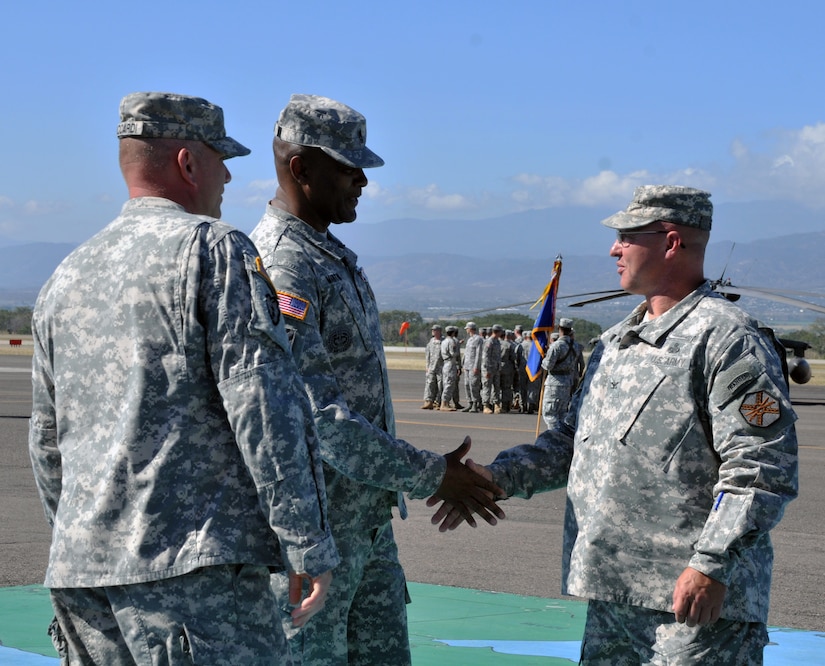 U.S. Army Col. John Sena, Army Support Activity Commander, shakes the hand of Joint Task Force-Bravo Command Sgt. Maj. Valmond A. Martin during a retirement ceremony conducted in Martin's honor at Soto Cano Air Base, Honduras, Jan. 29, 2014.  Martin enlisted in the U.S. Army in 1983 and has served for more than 31 years.  (Photo by Ana Fonseca)