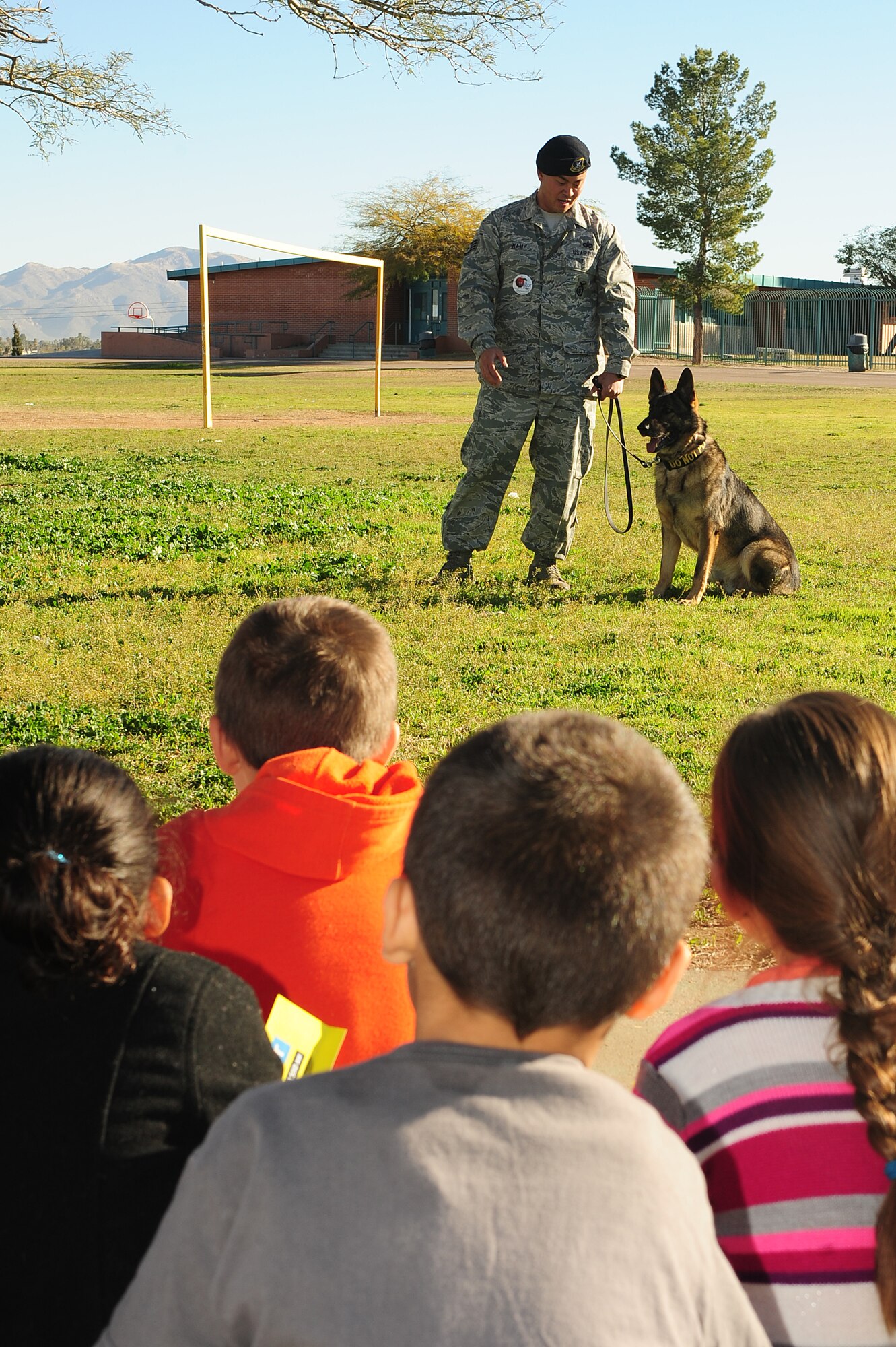 U.S. Air Force Staff Sgt. Ki Nam, 355th Security Forces Squadron Military Dog handler, and his partner, Benny, 355th SFS MWD, attended the career day at Dietz Elementary School, Tucson, Ariz., Jan. 29, 2014. Nam explained what a military working dog does and showed how MWDs are still very much like a beloved pet. _U.S. Air Force photo by Senior Airman Camilla Elizeu/ Released)