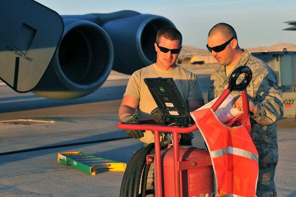 Staff Sgt. Mark Lash, 22nd Aircraft Maintenance Squadron crew chief, and Staff Sgt. Tyler Jeffreys, 92nd AMX hydrolics craftsman, perform aircraft post checks on a KC-135 Stratotanker after a mission during Red Flag 14-1 at Nellis Air Force Base, Nev., Jan. 28, 2014. More than 70 Airmen from McConnell AFB, Kan., and Fairchild AFB, Wash., team up for the three-week long exercise to keep these aircraft ready to do their mission. Red Flag has expanded to incorporate all spectrums of warfare to include command and control, real-time intelligence, analysis and exploitation, and electronic warfare. (U.S. Air Force photo by Staff Sgt. Veronica Montes/Released)   