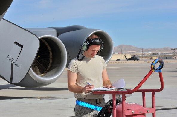 Staff Sgt. Ryan Carlson, 92nd Maintenance Squadron fuel systems repair journeyman, from Fairchild Air Force Base, Wash., reviews form for a KC-135 Stratotanker before takeoff during Red Flag 14-1 at Nellis AFB, Nev., Jan. 28, 2014. Red Flag was established in 1975 to better prepare Airmen for combat missions. (U.S. Air Force photo by Staff Sgt. Veronica Montes/Released)   