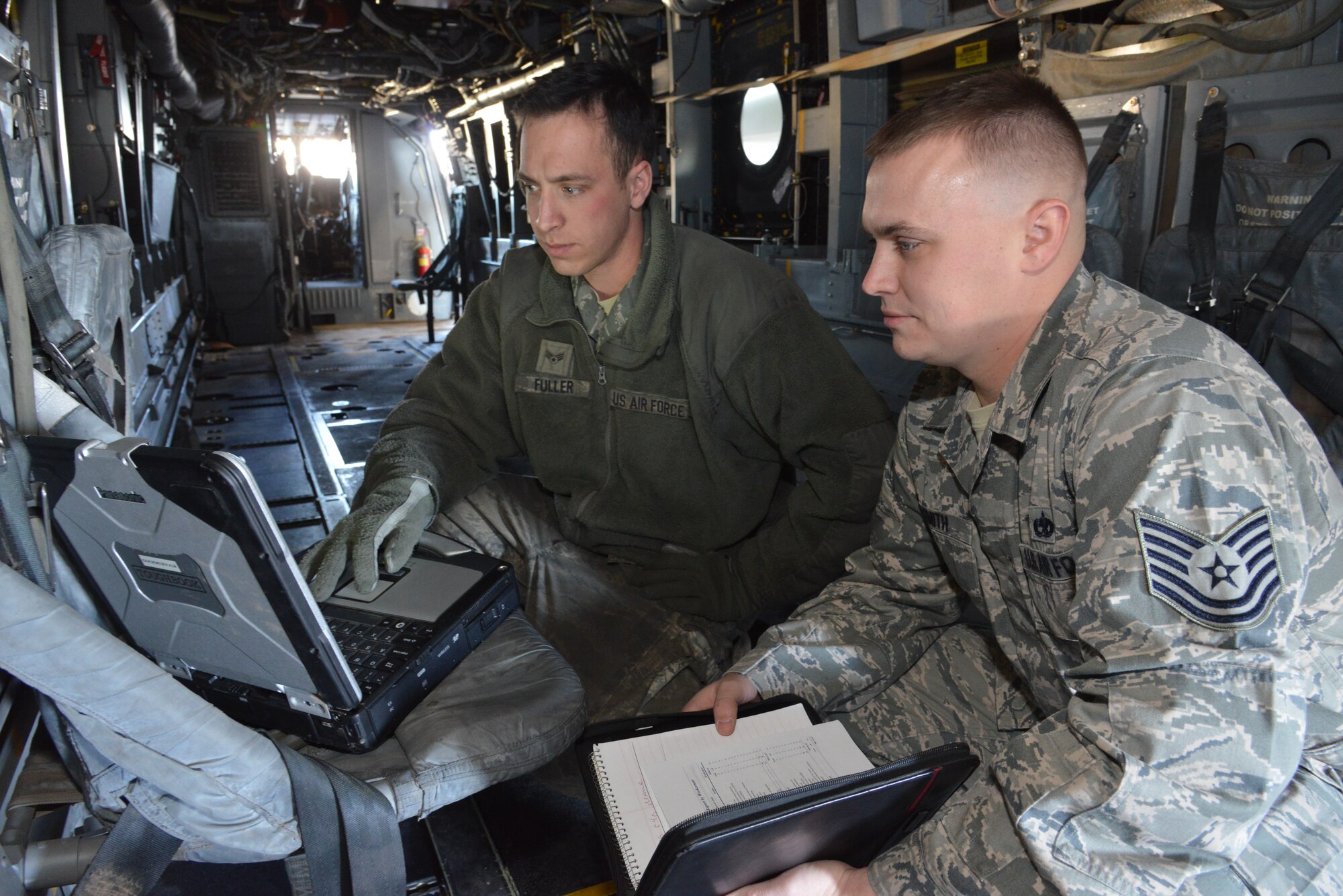 Right, Tech. Sgt. Trevor Smith, a craftsman in the 58th Maintenance Group, verifies technical data while performing a personal evaluation with Senior Airman Timothy Fuller. Smith was selected by his first sergeant for the Kirtland Warrior recognition. (Photo by Ken Moore)