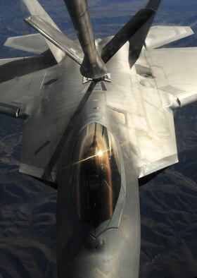 A KC-135 Stratotanker from the 93rd Air Refueling Wing from McConnell Air Force Base, Kan., refuels an F-22 Raptor from Joint Base Langley-Eustis, Va., during Red Flag 14-1 Jan. 28, 2014, over the Nevada Test and Training Range. More than 30 countries have participated directly in Red Flag. (U.S. Air Force photo/Staff Sgt. Veronica Montes/Released)