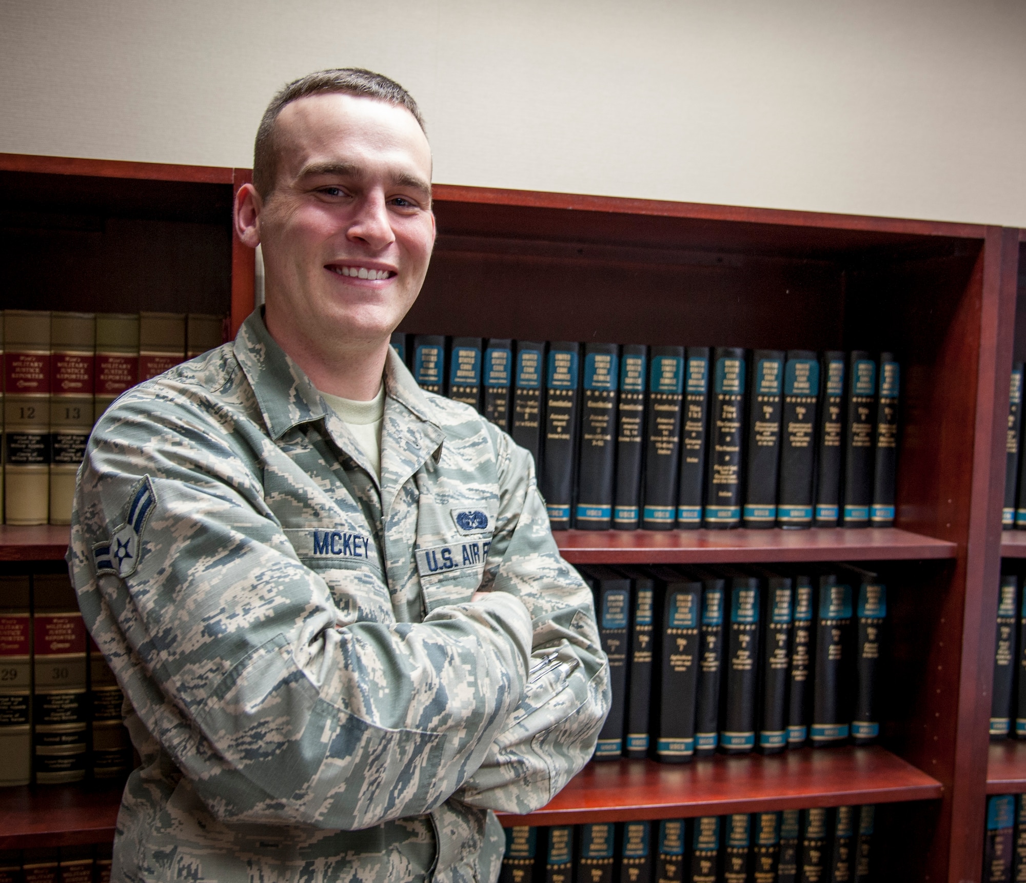 Airman 1st Class Trevor Mckey, 47th Flying Training Wing Judge Advocate legal assistant, poses for a photo in the Judge Advocate’s library at Laughlin Air Force Base, Texas, Jan. 23, 2014. Over the past year, Mckey has helped the Laughlin accomplish what no other Air Force wing in 2013 had done: meet 100 percent of the Air Force’s Article 15 metrics designed to ensure investigations are proper and swift. (U.S. Air Force photo/Senior Airman John D. Partlow)