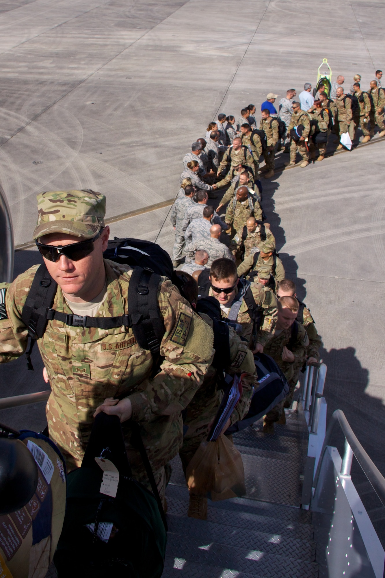 Airmen shake hands and say farewell to base leadership prior boarding the aircraft at Homestead Air Reserve Base, Fla, in January. More than 300 Airmen from the base deployed to Southwest Asia and Europe in support of contingency operations. (U.S. Air Force photo by/Tech. Sgt. Lionel Castellano)
