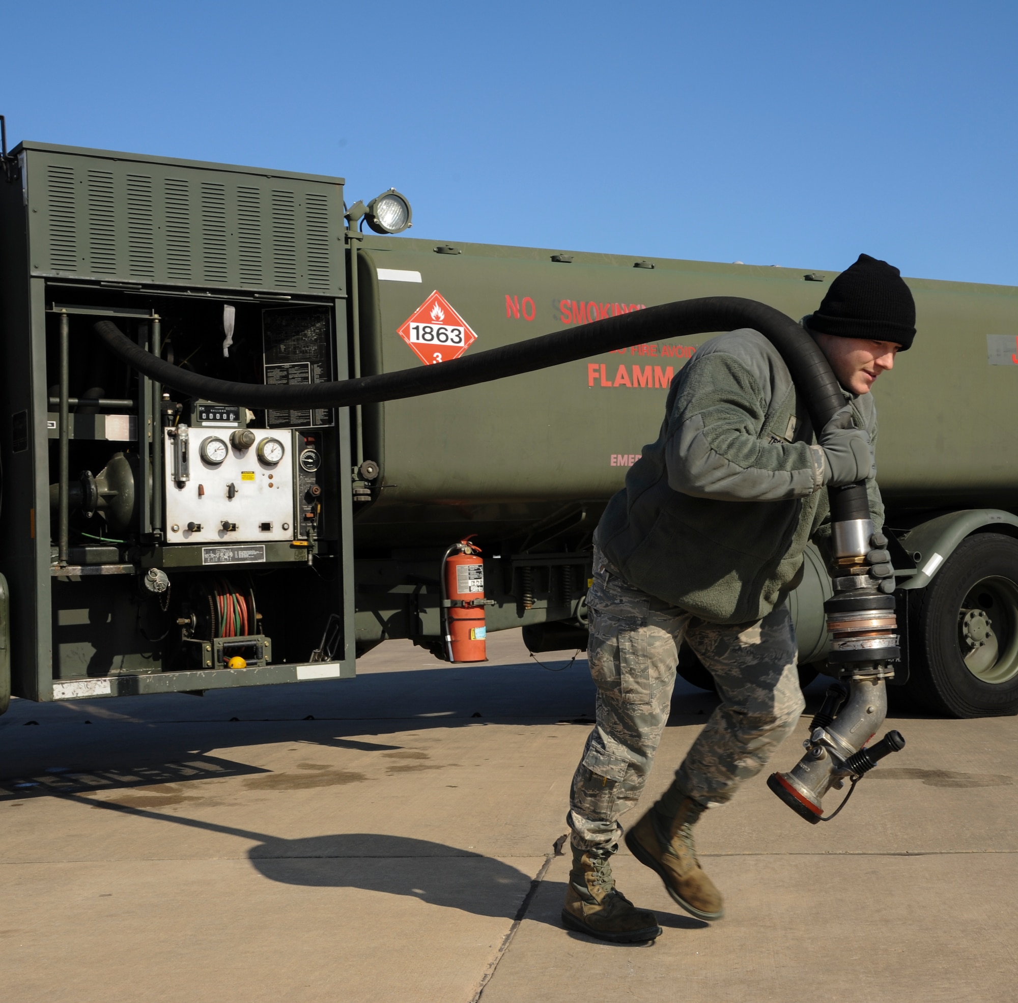 Senior Airman Noah TeGrootenhuis, a 19th Logistics Readiness Squadron fuels distribution operator, pulls a fuel hose toward a C-130 Jan. 29, 2014, at Little Rock Air Force Base, Ark. The 19th LRS refuels more than 90 C-130H/J aircraft at Little Rock Air Force Base. (U.S. Air Force photo by Airman 1st Class Harry Brexel)