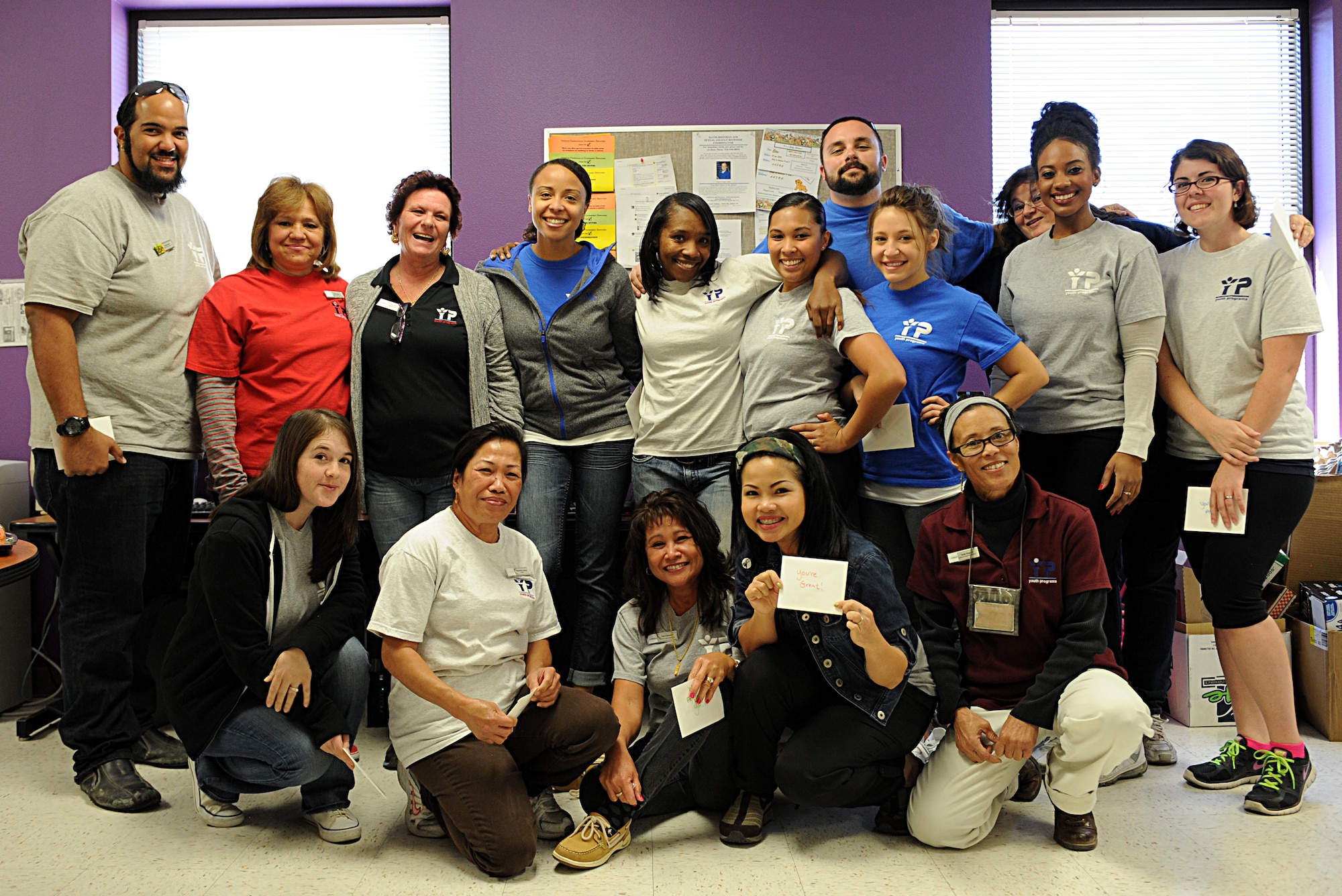 The School Age Program staff poses for a group photo during a luncheon at Davis-Monthan Air Force Base, Ariz., Jan. 28, 2014. The luncheon was a part of a staff appreciation day put together by several parents in conjunction with the program's Parent Advisory Board. (U.S. Air Force photo by Airman 1st Class Chris Drzazgowski/Released)