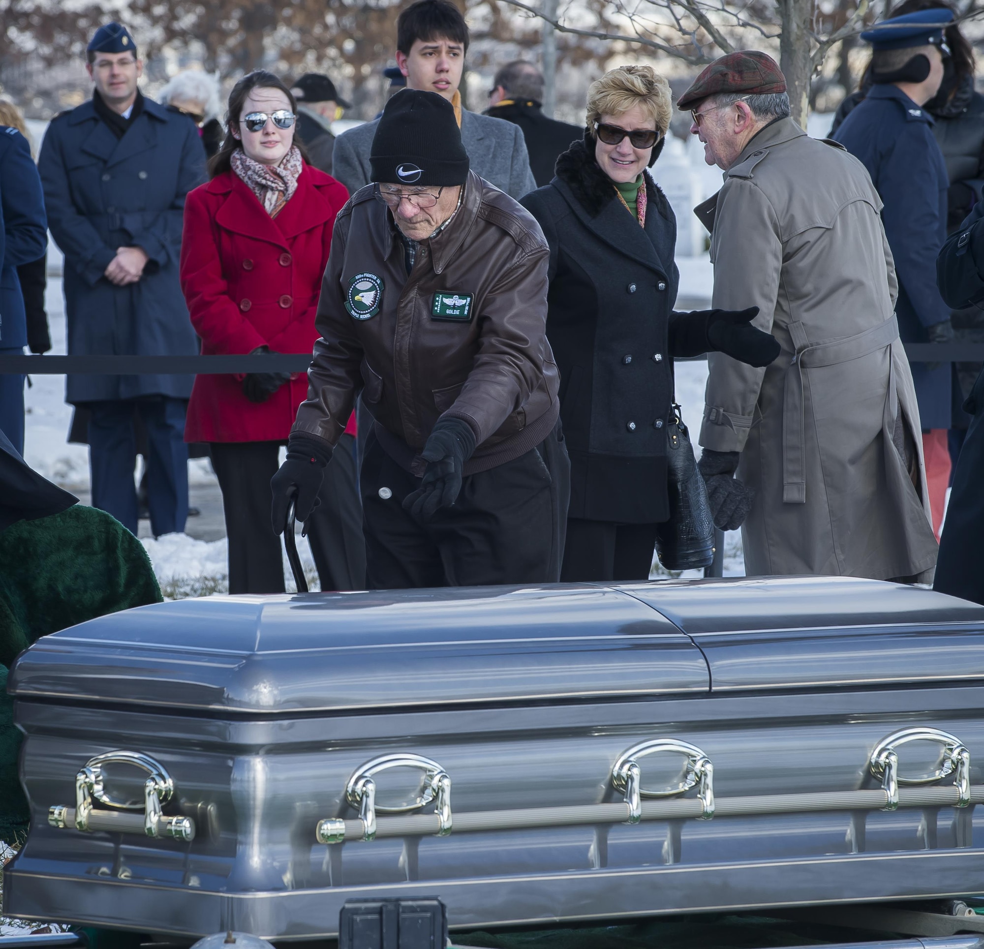 A friend of Brig. Gen. Robinson "Robbie" Risner pays his respects following Risner's Full Honors Military Funeral at Arlington National Cemetery, Arlington, Va., Jan. 23, 2014. Risner was the Air Force's 20th Ace and survived seven and a half years of captivity as a Prisoner of War (POW) in Hoa Lo Prison, a.k.a the Hanoi Hilton, during the Vietnam War. (U.S. Air Force photo/Jim Varhegyi)